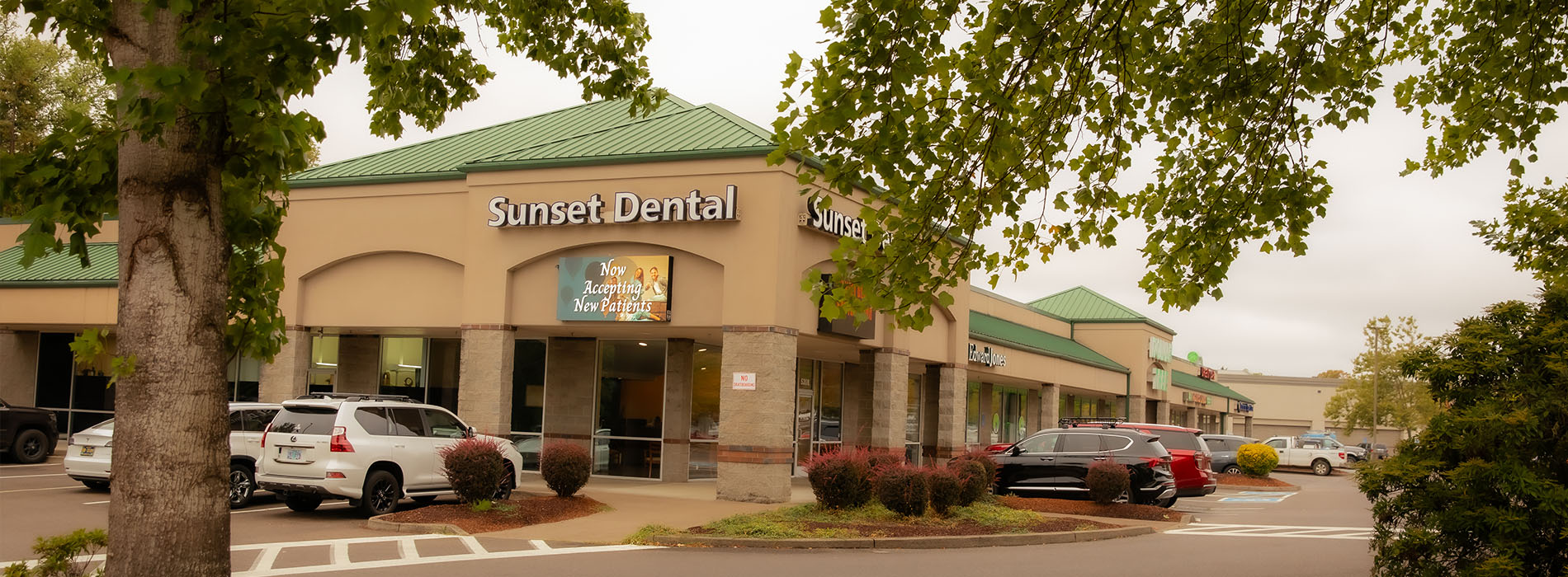 The image shows a modern dental clinic interior with various pieces of equipment, including a dental chair and an X-ray machine.
