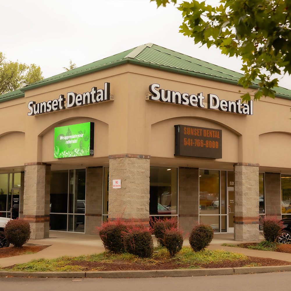 The image shows a dental office interior with a dental chair, a dental light, and various dental equipment.
